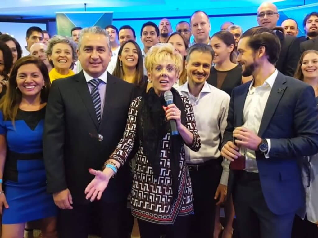 Woman with microphone leading smiling diverse group